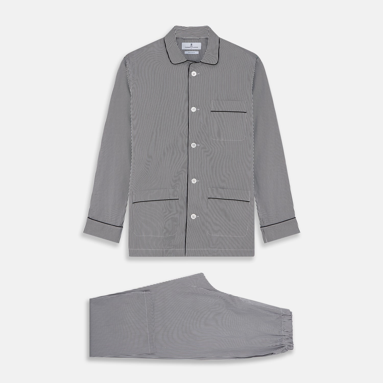 View 1 of product The Turnbull & Asser Black Candy Stripe Cotton Hyde Pyjama Set for men features soft cotton striped pajamas with a long-sleeve, button-up shirt detailed with black piping and three pockets, plus matching pants, both laid flat on a white background.