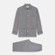 The Turnbull & Asser Black Candy Stripe Cotton Hyde Pyjama Set for men features soft cotton striped pajamas with a long-sleeve, button-up shirt detailed with black piping and three pockets, plus matching pants, both laid flat on a white background.