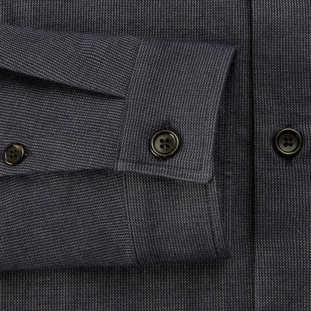 The Turnbull & Asser Navy Hampstead Overshirt features a collar, left chest pocket, two zippered pockets near the bottom, and a classic long-sleeve button-up design, shown laid flat on a white background.