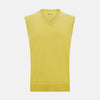 View 1 of product Turnbull & Asser’s Canary Yellow Cashmere V-Neck Vest features a ribbed hem and sleeveless design, adding a vibrant touch to refined outfits. Displayed on a plain white background.