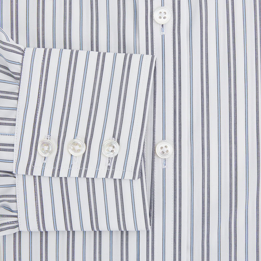 The Turnbull & Asser Navy Multi Stripe Mayfair Shirt features a T&A collar and premium Italian cotton, with vertical blue and white stripes. It is shown neatly laid flat on a white background.