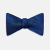 View 1 of product The HOUNDSTOOTH NAVY CRUISE BOW TIE by Turnbull & Asser features a refined textured pattern in blue, neatly tied and set against a white background—a stylish, versatile accessory for the modern gentleman.