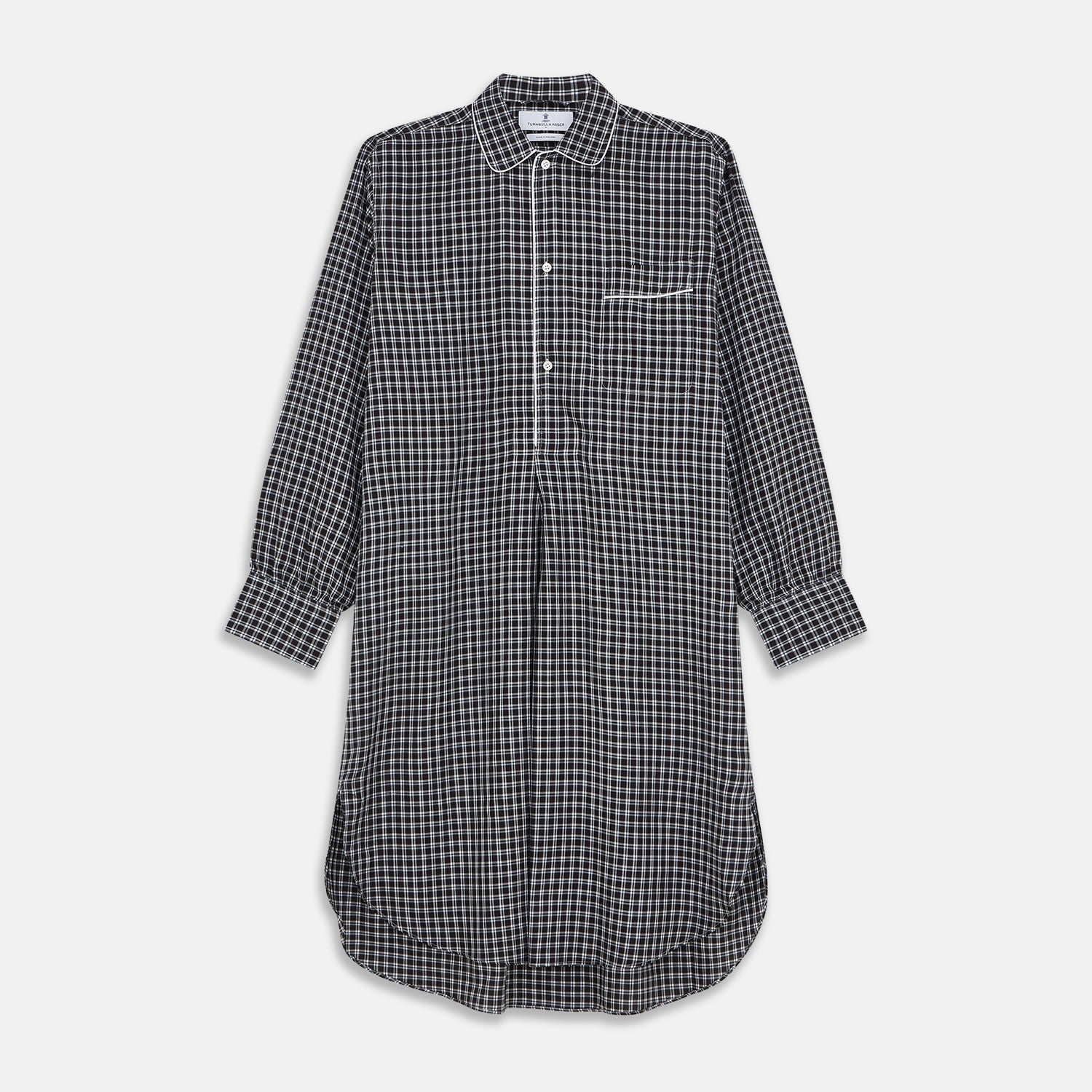 View 1 of product The Turnbull & Asser Black Multi Check Cotton Blend Sussex Nightshirt features a long sleeve, knee-length design with front buttons, a pointed collar, and chest pocket—ideal for those who love luxury sleepwear.