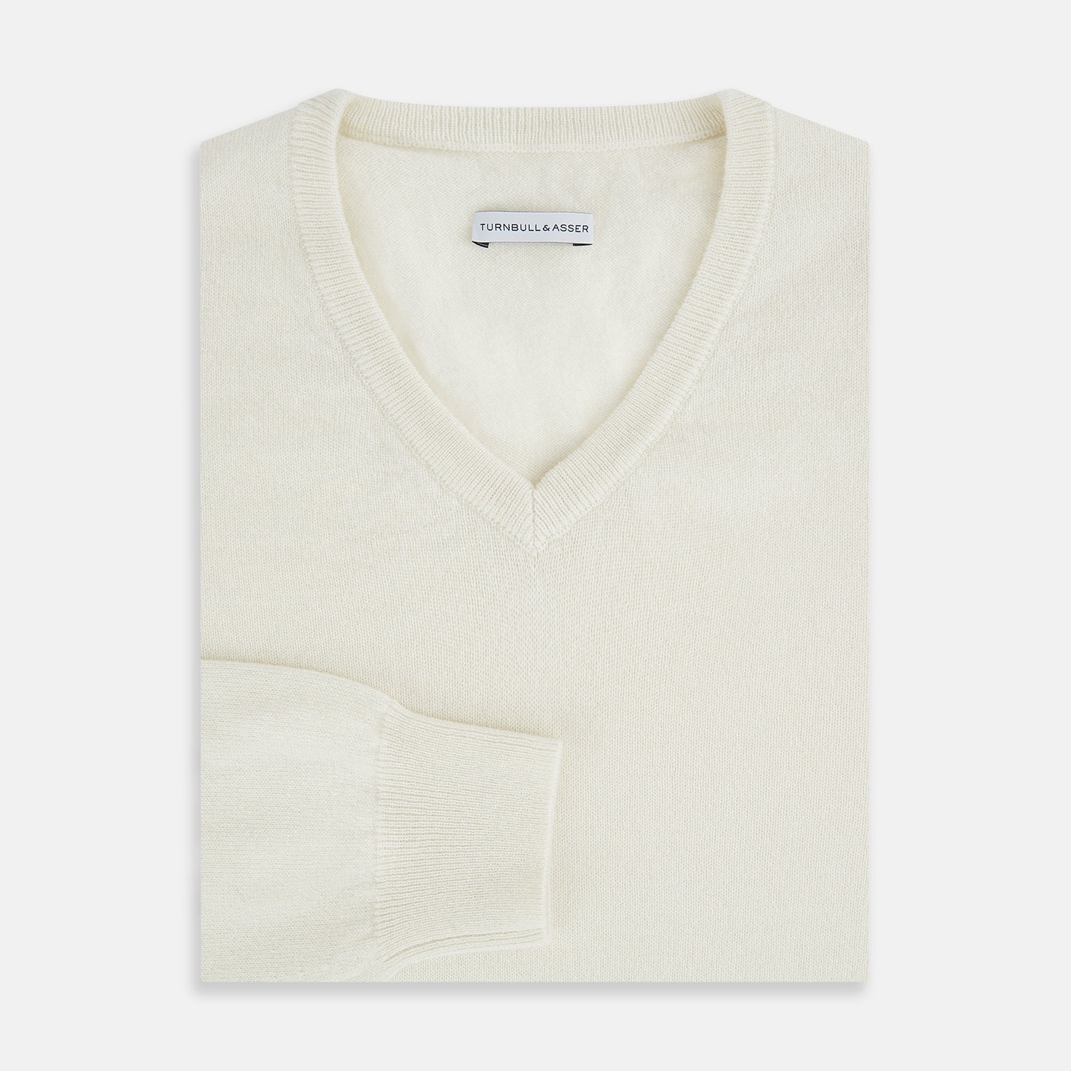View 4 of product The Turnbull & Asser White Cashmere V-Neck Jumper features long sleeves and a versatile light cream shade, making it a timeless addition to your knitwear collection.