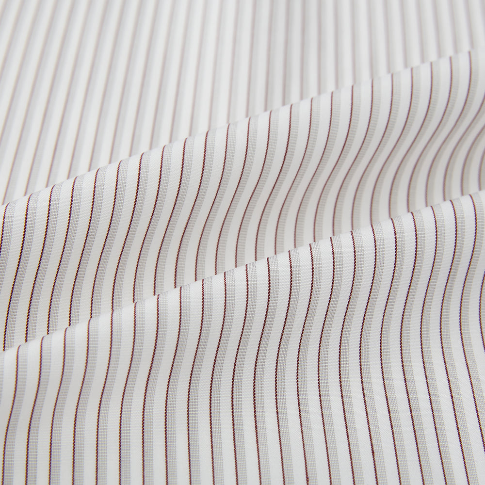 The Coffee and Grey Shadow Pinstripe Westminster Shirt by Turnbull & Asser features thin white and gray stripes, a long sleeve, button-down style, and signature collar, all reflecting classic British craftsmanship.