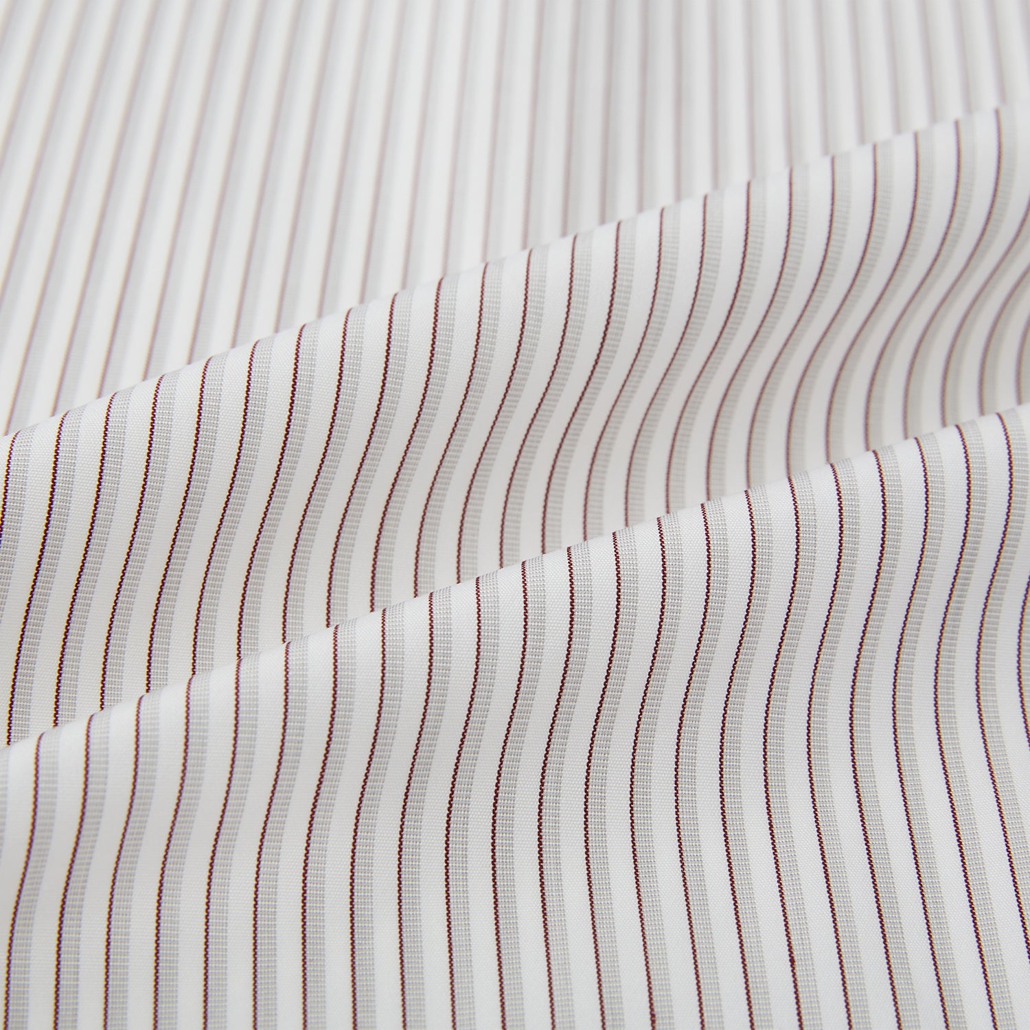 View 8 of product The Coffee and Grey Shadow Pinstripe Westminster Shirt by Turnbull & Asser features thin white and gray stripes, a long sleeve, button-down style, and signature collar, all reflecting classic British craftsmanship.