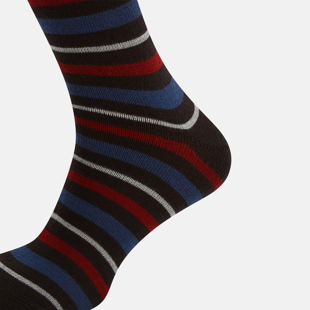 The Turnbull & Asser Dark Chocolate Striped Merino Wool Long Socks are knee-high, featuring horizontal black, red, blue, and gray stripes on a white background.
