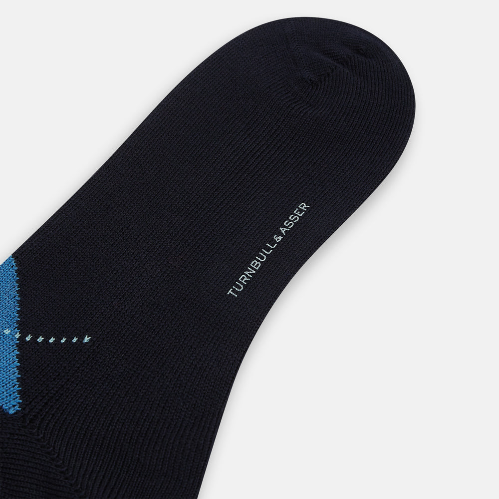 A single Turnbull & Asser Navy/Blue Wool Check Mid-Length Sock, featuring a blue and light blue check pattern, is displayed upright on a plain white background.