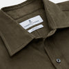 View 2 of product The Turnbull & Asser Khaki Green Linen Weekend Fit Langston Shirt features long sleeves, a classic Derby collar, two chest pockets, and buttoned cuffs, shown against a white background.