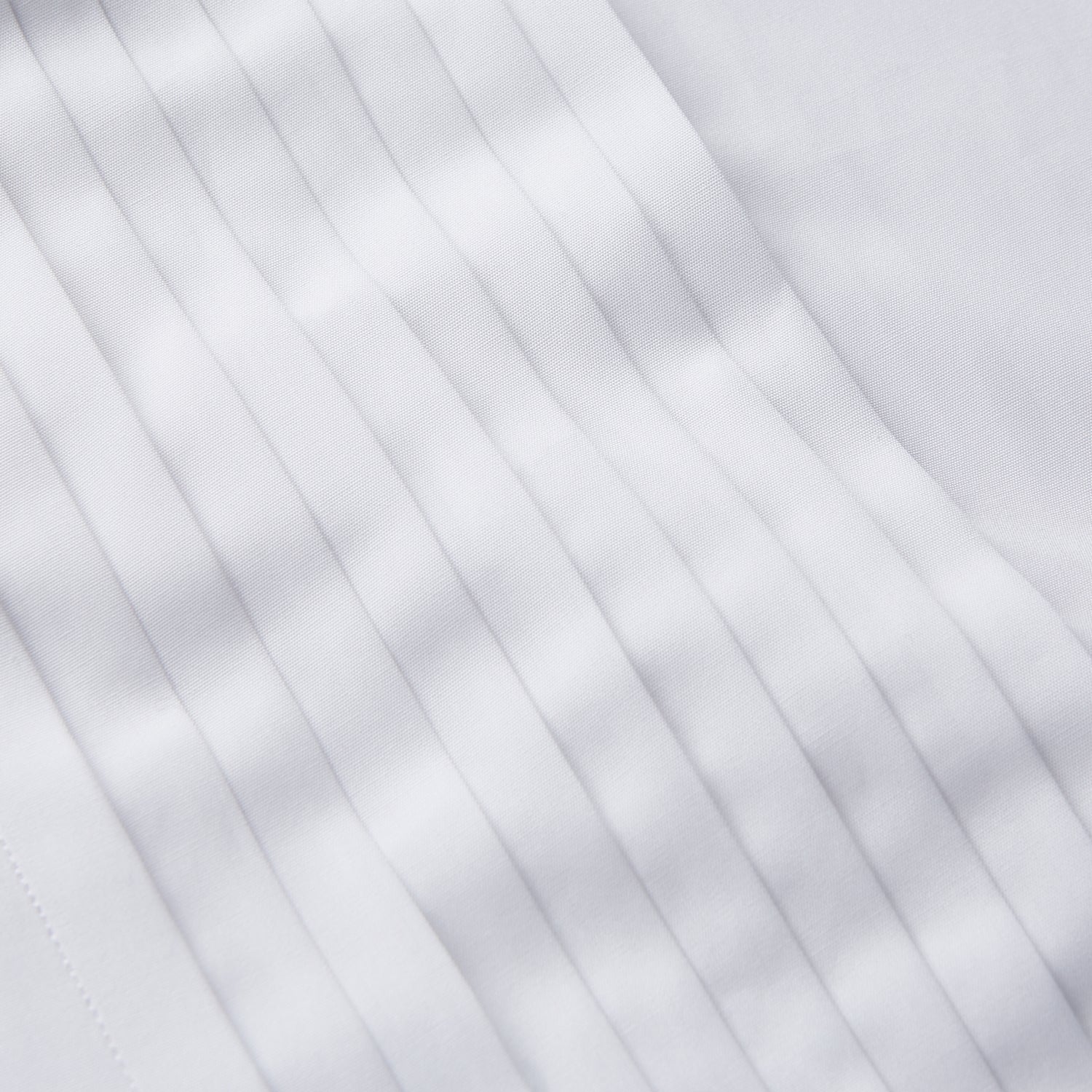 View 5 of product The Turnbull & Asser White Pleated Cotton Dress Shirt features a T&A collar and double cuffs, shown laid flat on a white background.