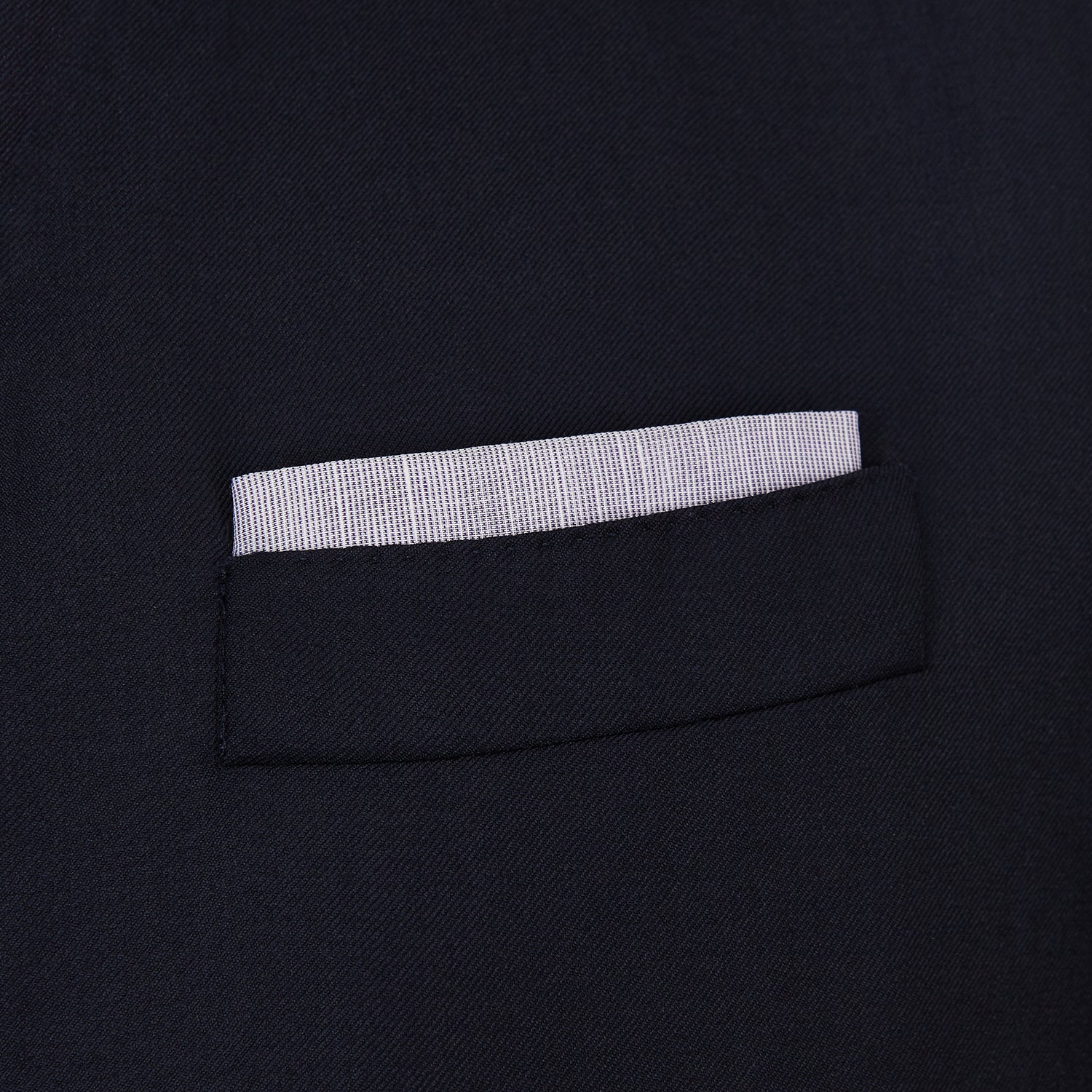 View 2 of product The Lilac Cotton-Blend Handkerchief by Turnbull & Asser is neatly folded with a corner flipped over, exposing the hand-rolled edges, and displayed against a white background.