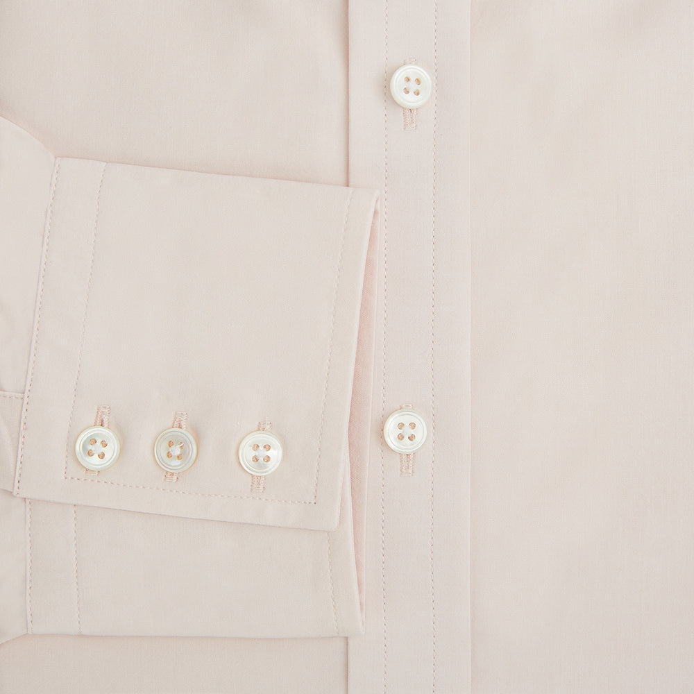 A plain, long-sleeve Pale Pink Mayfair Shirt by Turnbull & Asser with a T&A collar and buttoned cuffs, laid flat on a white background.