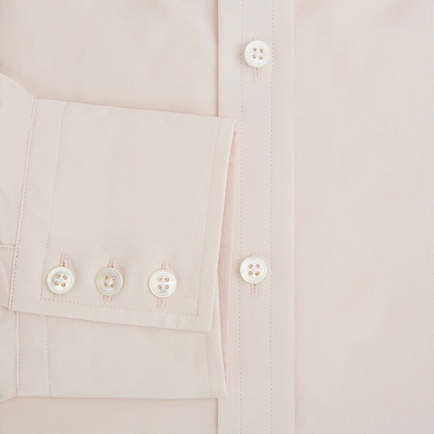 View 4 of product A plain, long-sleeve Pale Pink Mayfair Shirt by Turnbull & Asser with a T&A collar and buttoned cuffs, laid flat on a white background.