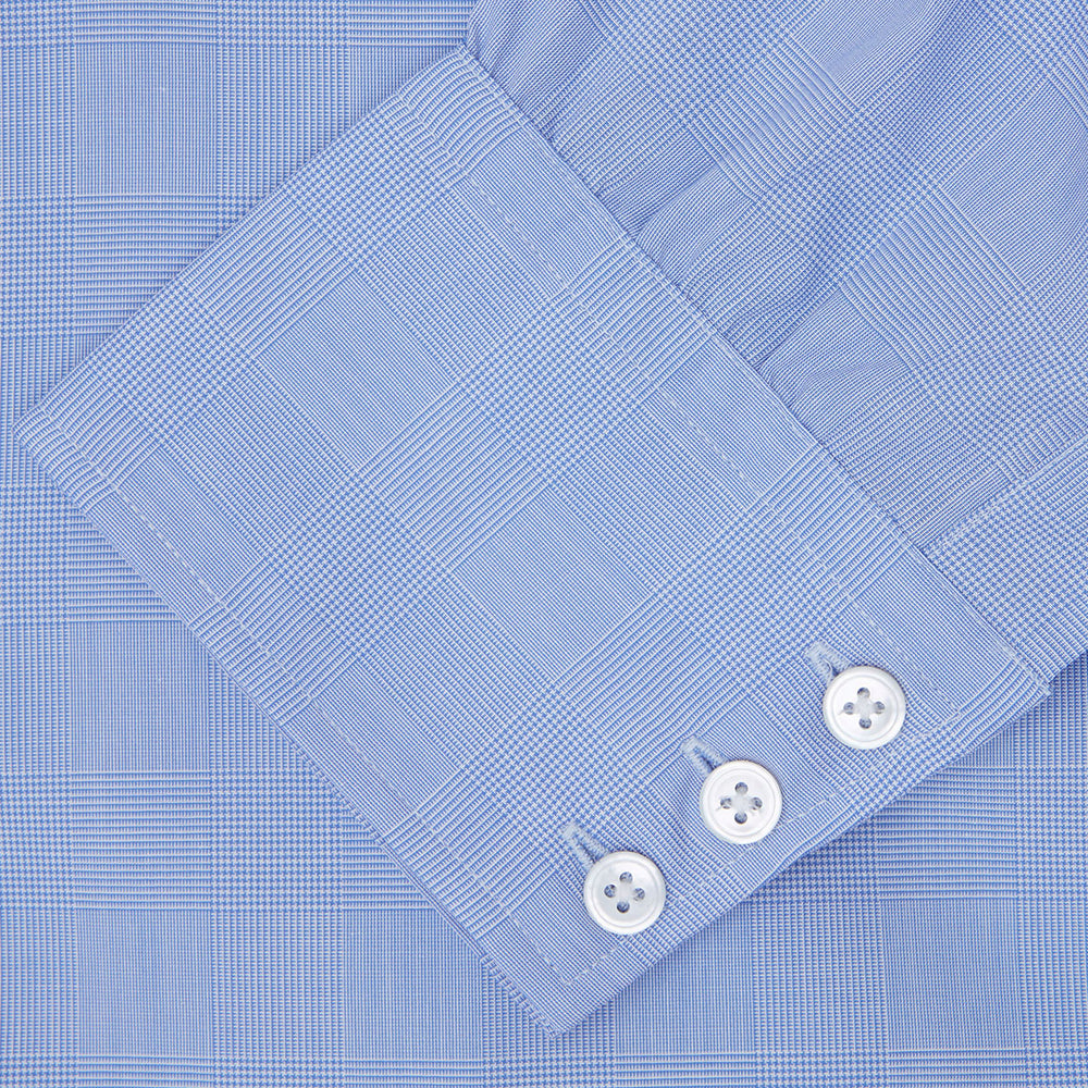 A Blue Prince of Wales Check Shirt by Turnbull & Asser, featuring a T&A collar and 3-button cuffs, is neatly folded and displayed on a plain white background.