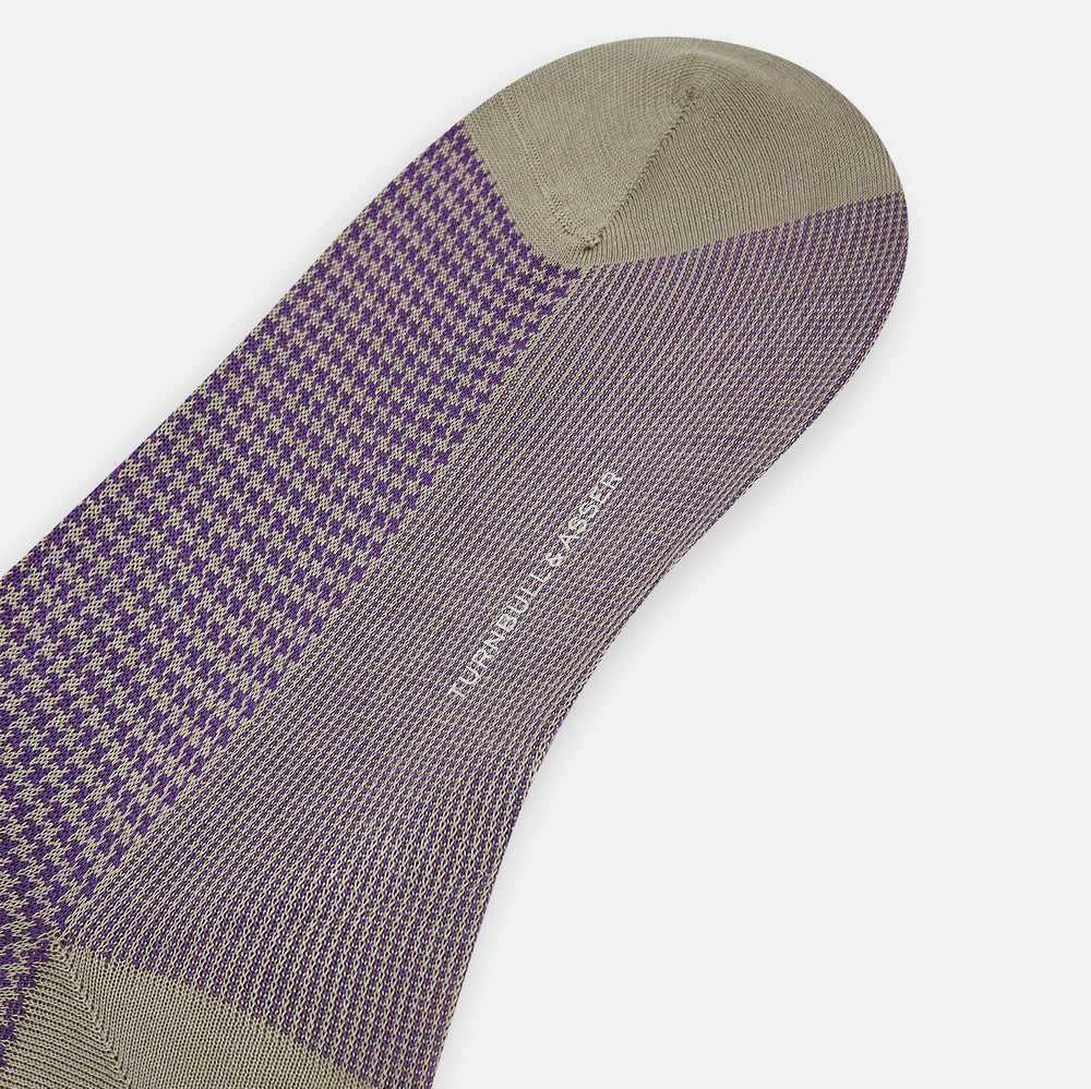 The Concrete Houndstooth Long Sock by Turnbull & Asser features a knee-high design with beige cuff, toe, and heel, plus a purple and black checkered pattern, shown on a plain white background.