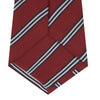 View 4 of product The Turnbull & Asser GGT92000 3042 48 OS is a rolled-up red cotton silk stripe tie with diagonal white and navy blue stripes, displayed on a plain white background.