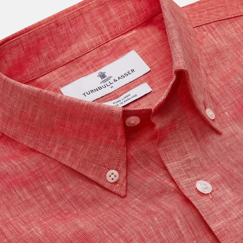 The Turnbull & Asser Pink Linen Weekend Fit Hayne Shirt is a casual, long-sleeve button-down with a subtle texture and white buttons, neatly laid flat on a white background.