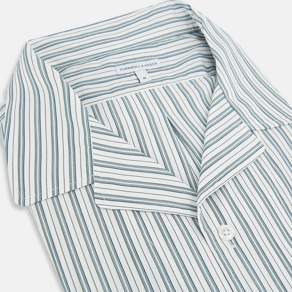 The Green Double Stripe Quarzo Nightshirt by Turnbull & Asser is a relaxed-fit, long-sleeve, knee-length Italian cotton shirt dress with a collar, partial button-down front, chest pocket, and buttoned cuffs in green and white stripes.