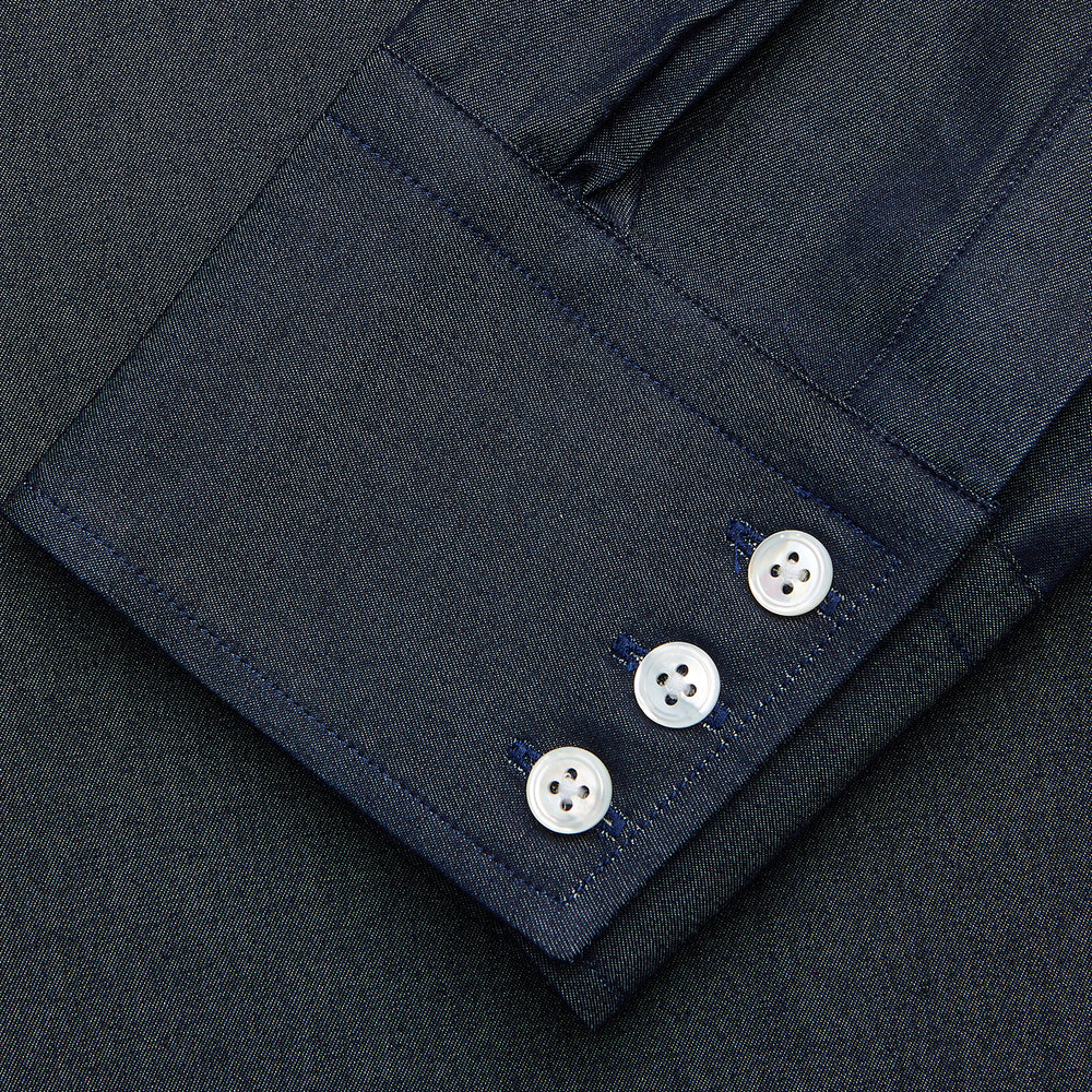 The Turnbull & Asser Navy Weekend Fit Larkin Shirt features a Dorset collar, long sleeves with 3-button cuffs, two chest pockets, and white snaps, shown laid flat against a white background.