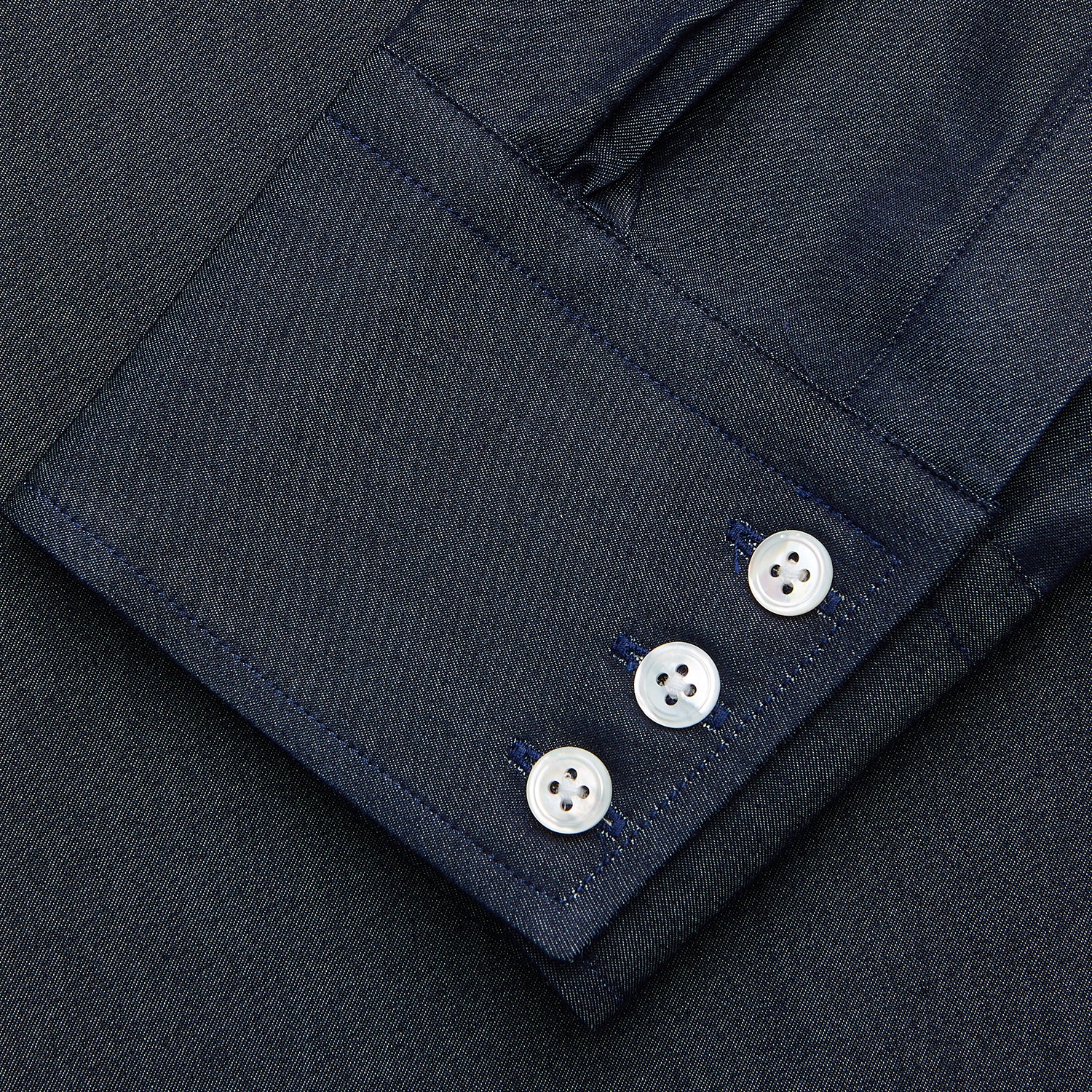 View 3 of product The Turnbull & Asser Navy Weekend Fit Larkin Shirt features a Dorset collar, long sleeves with 3-button cuffs, two chest pockets, and white snaps, shown laid flat against a white background.