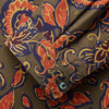 View 2 of product The Turnbull & Asser Khaki Green Floral Silk Holiday Fit Winnington Shirt features a bold floral print with orange, yellow, and purple on an olive background, plus a spread collar and chest pocket for versatile style.