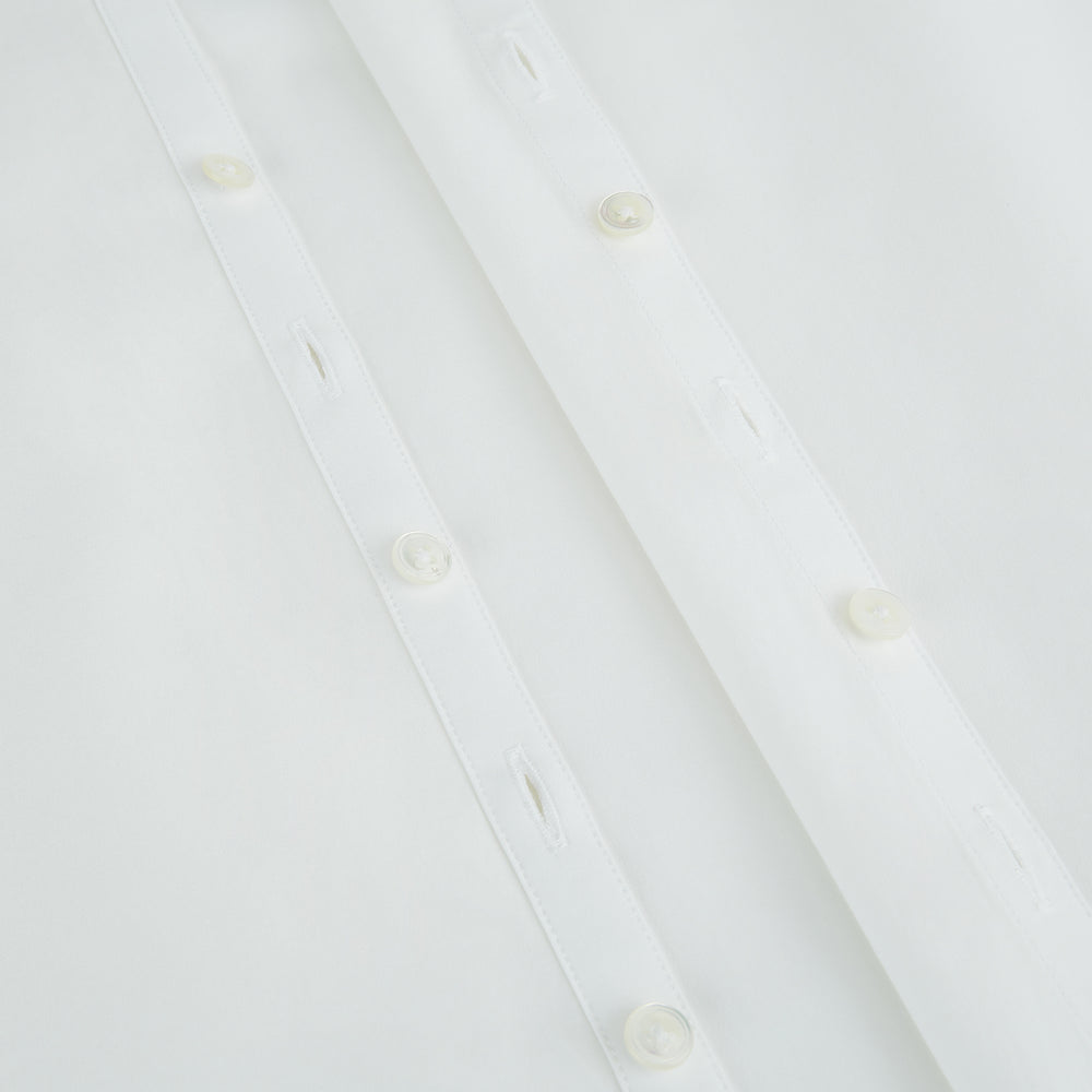 The Turnbull & Asser Plain White Windsor Shirt features a Turnbull open collar, 3-button cuffs, and relaxed fit—exemplifying British craftsmanship. Displayed on a white background.