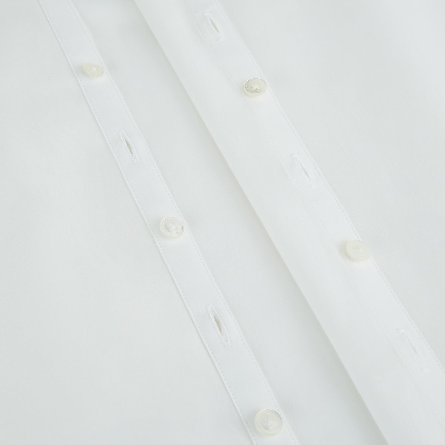 View 7 of product The Turnbull & Asser Plain White Windsor Shirt features a Turnbull open collar, 3-button cuffs, and relaxed fit—exemplifying British craftsmanship. Displayed on a white background.