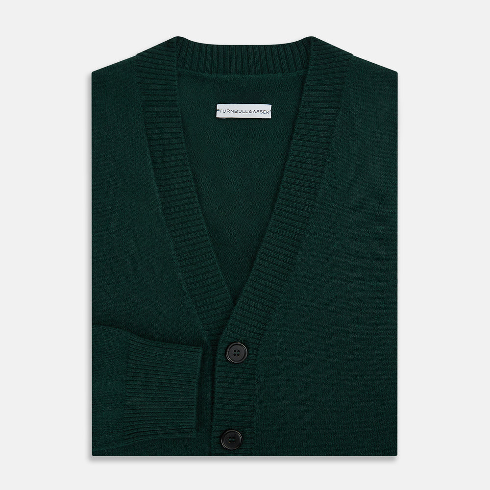 The Turnbull & Asser Forest Green Cashmere Cardigan—featuring long sleeves, a V-neck, button-down front, ribbed cuffs and hem, plus two front pockets—is shown against a plain white background.