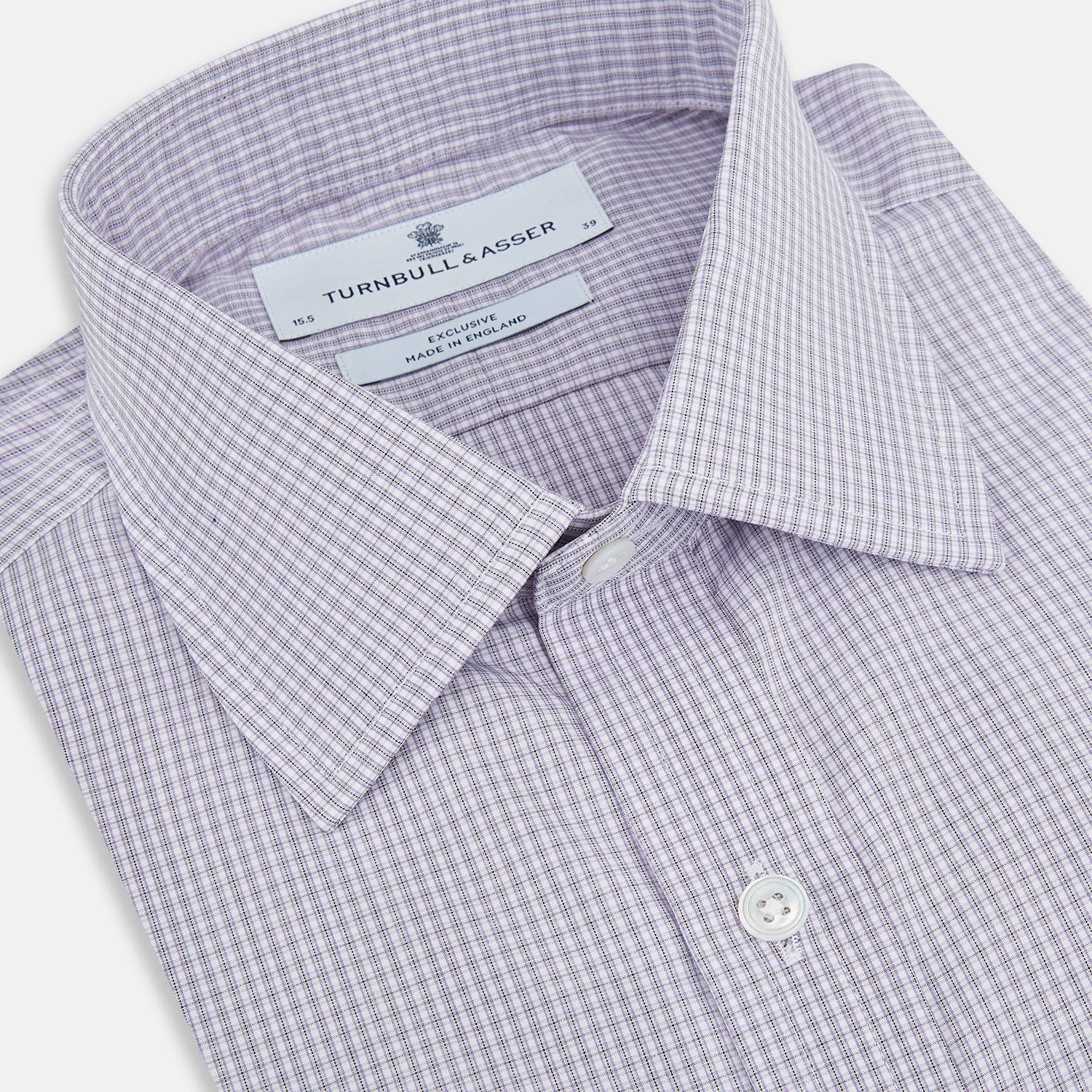 View 2 of product The Turnbull & Asser Purple Micro Check Mayfair Shirt features long sleeves, button-up front, pointed collar, and buttoned cuffs in a subtle lilac and white check, exemplifying British craftsmanship and displayed on a white background.
