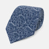 View 1 of product The Turnbull & Asser Pale Blue Paisley Silk Tie, featuring a blue paisley pattern on a pale blue background, is shown rolled up on a plain white surface.