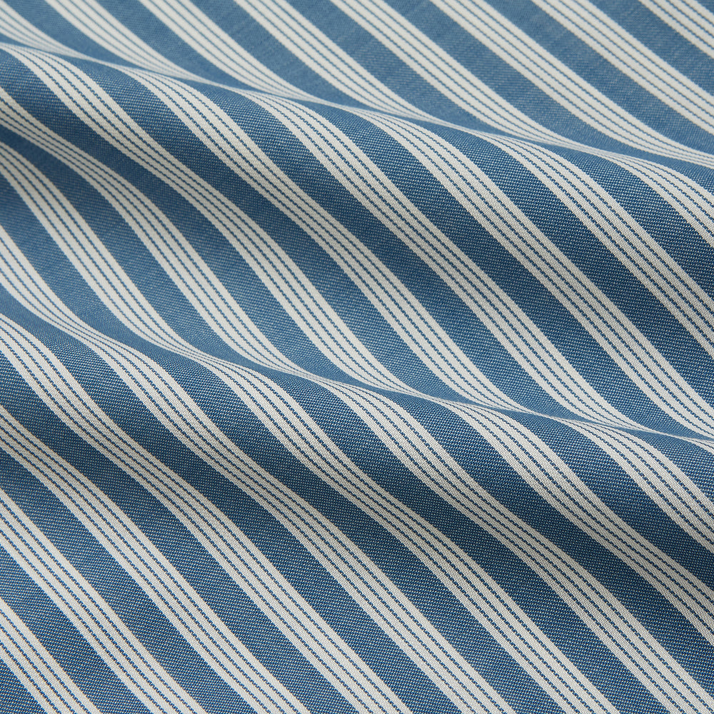 Turnbull & Asser’s Pale Blue Multi Stripe Weekend Fit Wool Shirt features a Derby collar, 1-button cuffs, and a chest pocket—ideal for casual layering. Shown laid flat on a white background for easy styling.