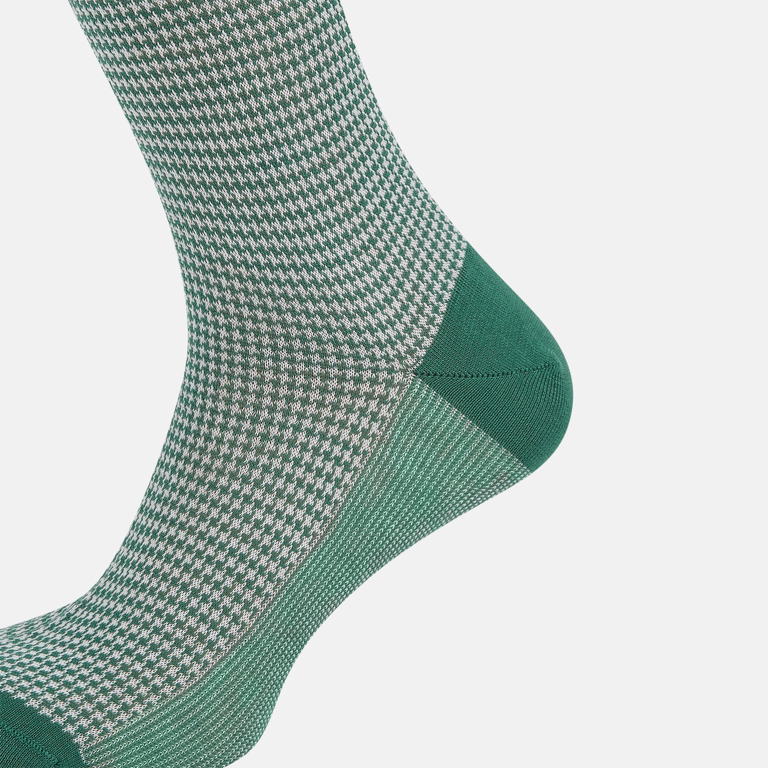 View 4 of product The Ivory/green Houndstooth Long Sock by Turnbull & Asser features a houndstooth pattern on the lower half with a solid green upper band, heel, and toe, shown against a white background.