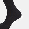 View 4 of product A Charcoal Dash Striped Mid-Length Sock from Turnbull & Asser is shown on a plain white background, positioned to emphasize its ribbed texture and length.