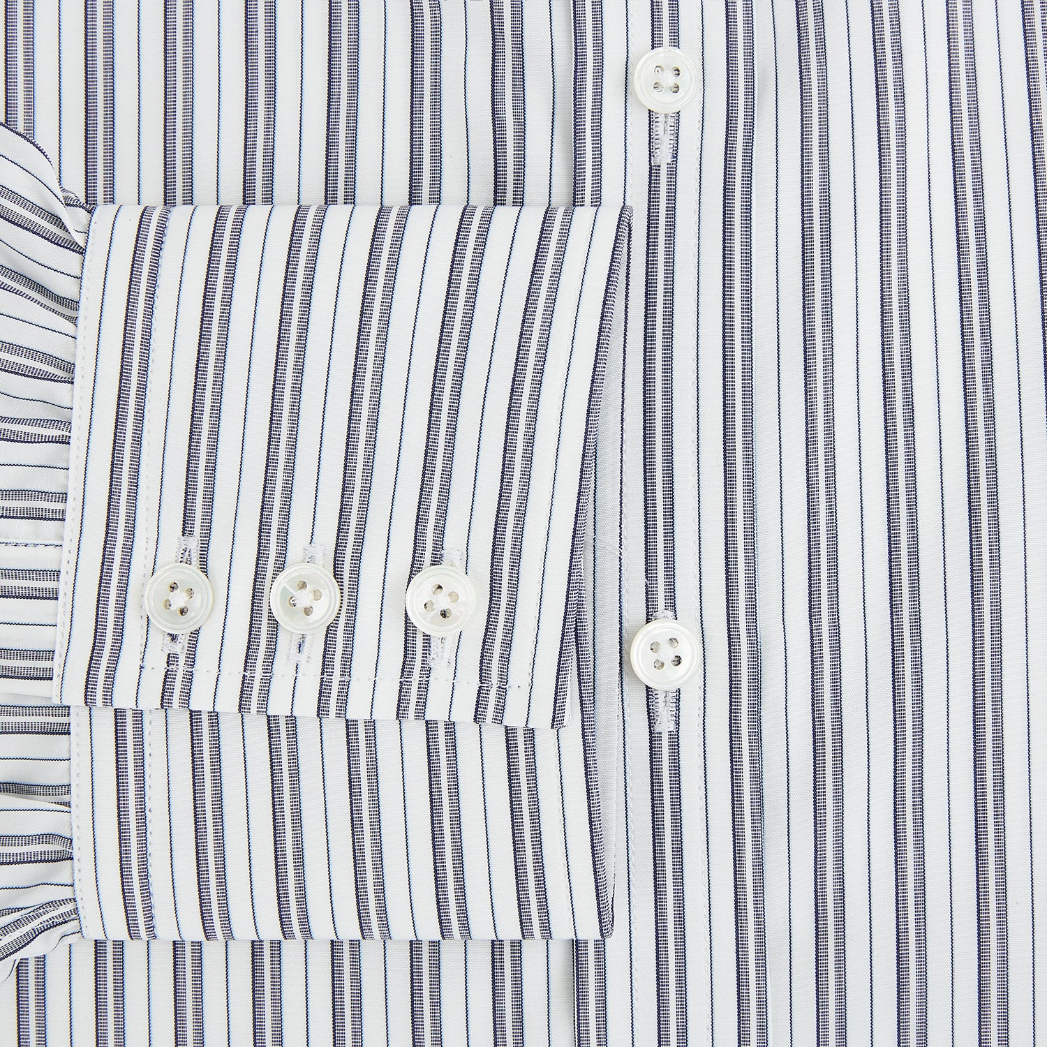 View 4 of product The Turnbull & Asser Navy Multi Stripe Mayfair Shirt, a pure cotton button-up with long sleeves and a collar, features thin vertical blue and white stripes and is displayed flat on a white background.