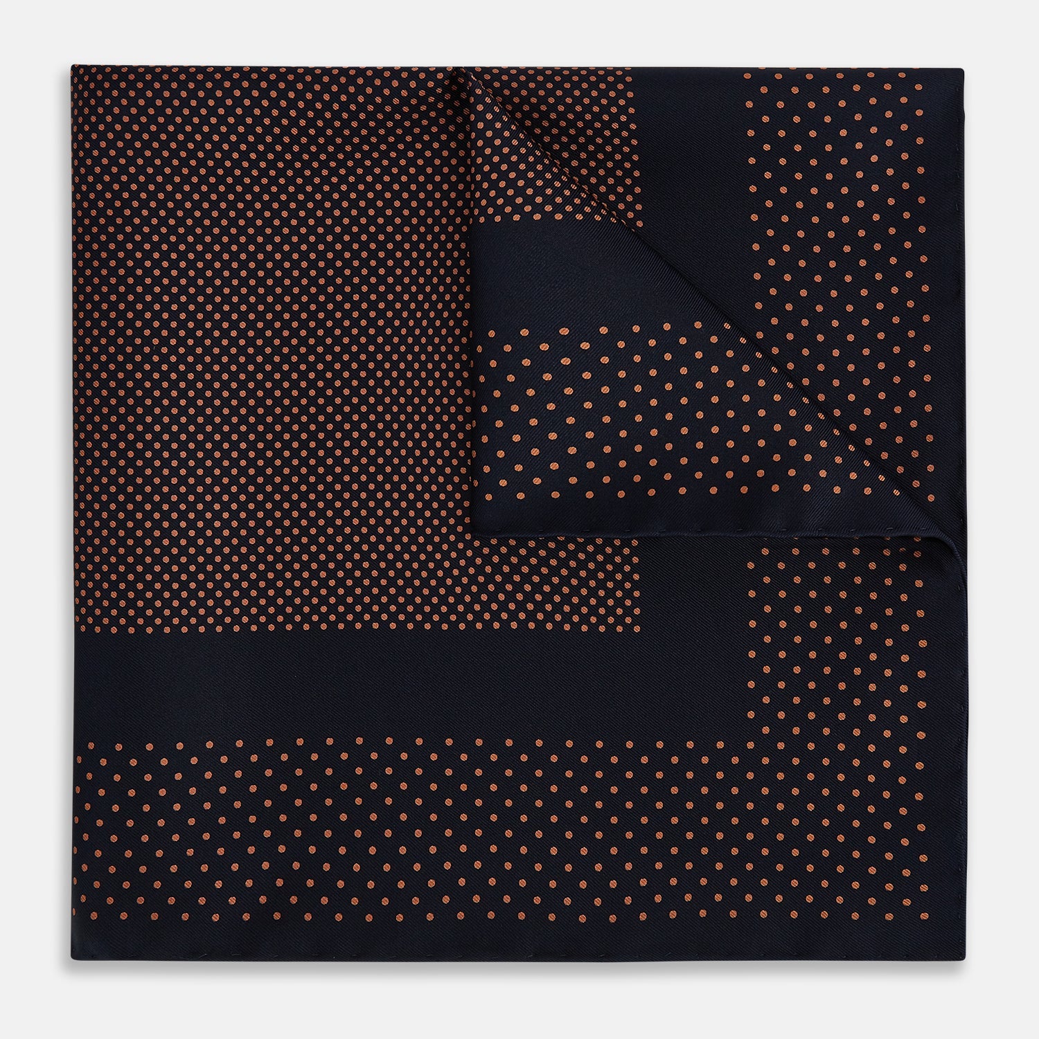 View 1 of product The Navy and Blush Dot Silk Pocket Square by Turnbull & Asser features a navy base with small orange polka dots and a border, shown neatly folded with one corner flipped over.