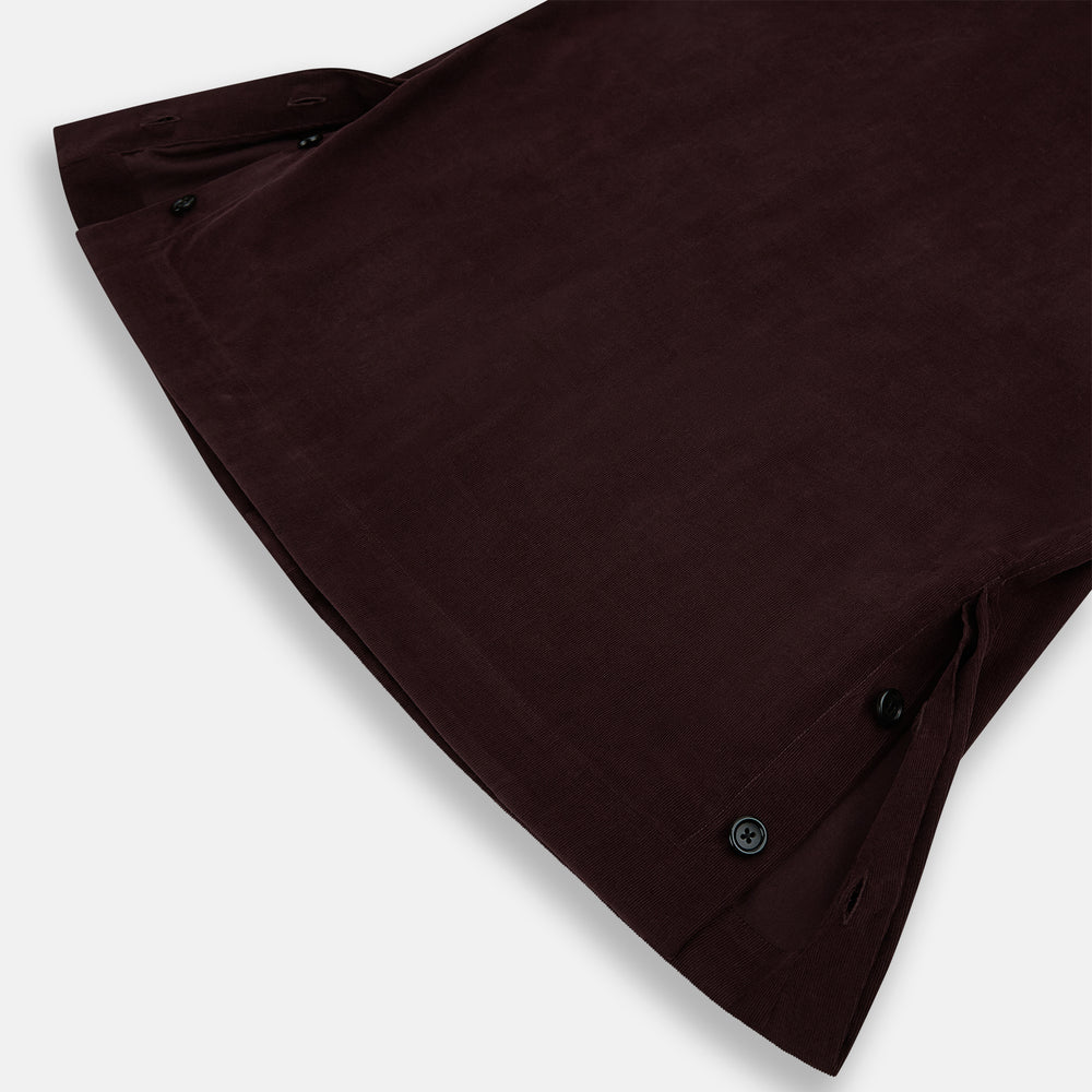 The Turnbull & Asser Burgundy Corduroy Hampstead Overshirt features long sleeves, a collar, a large left chest pocket, and two zippered side pockets, shown laid flat on a plain white background.