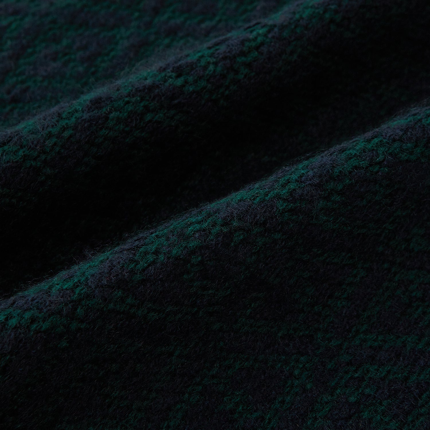 View 3 of product The Turnbull & Asser Navy Blue and Forest Green Diamond-Patterned Cashmere Knitted Scarf features a subtle textured design, shown loosely draped with ends hanging down—an essential, stylish addition to any cool-weather wardrobe.