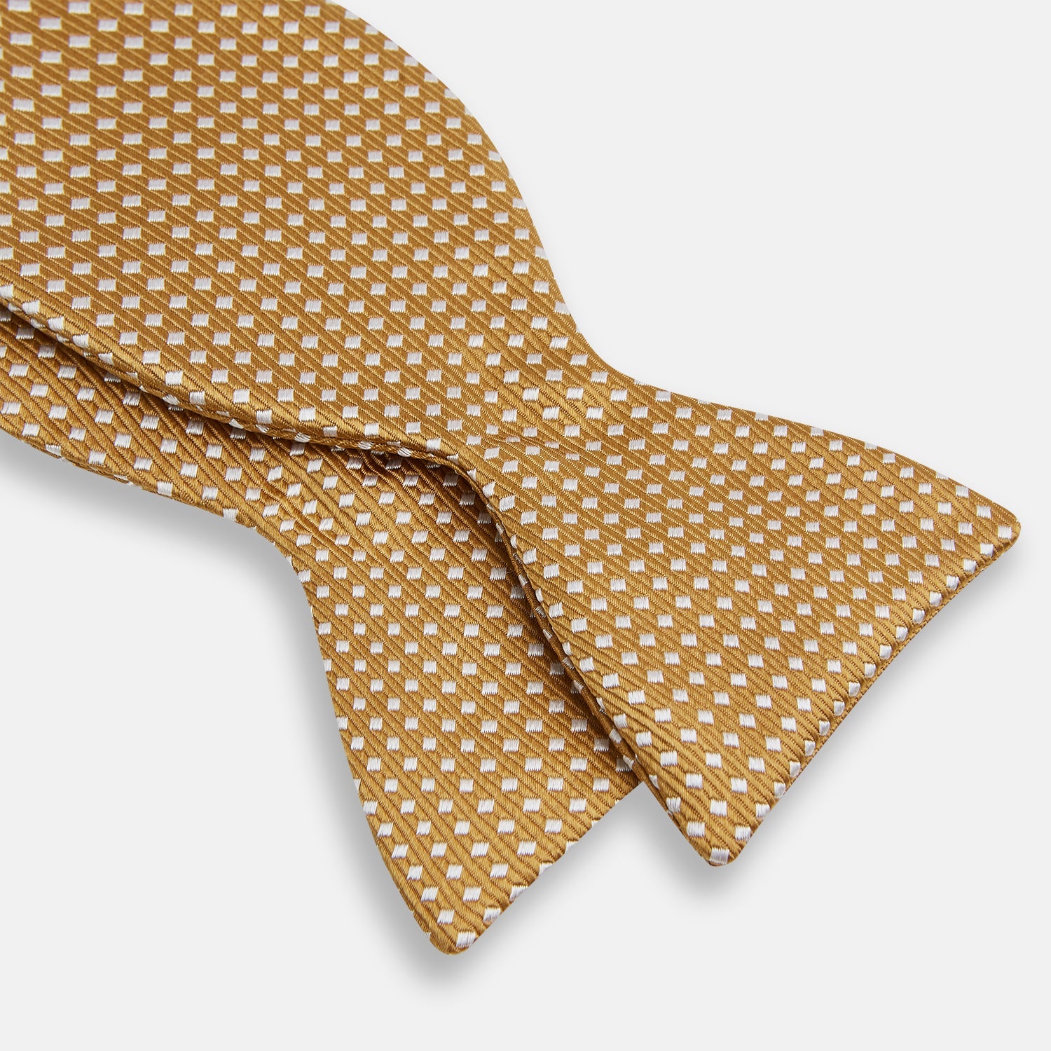 View 3 of product The Turnbull & Asser Camel and White Diamond Silk Bow Tie features a ribbed texture with evenly spaced white diamond shapes, offering an elegant accessory for formalwear, shown on a white background.