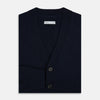 View 4 of product The Navy V-Neck Cashmere Cardigan by Turnbull & Asser features a button-up front, ribbed cuffs and hem, and two front pockets—a classic from our knitwear collection.