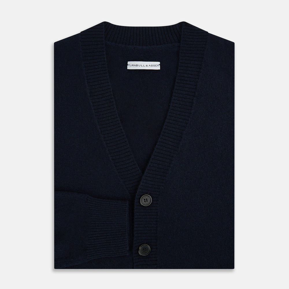 The Navy V-Neck Cashmere Cardigan by Turnbull & Asser features a button-up front, ribbed cuffs and hem, and two front pockets—a classic from our knitwear collection.