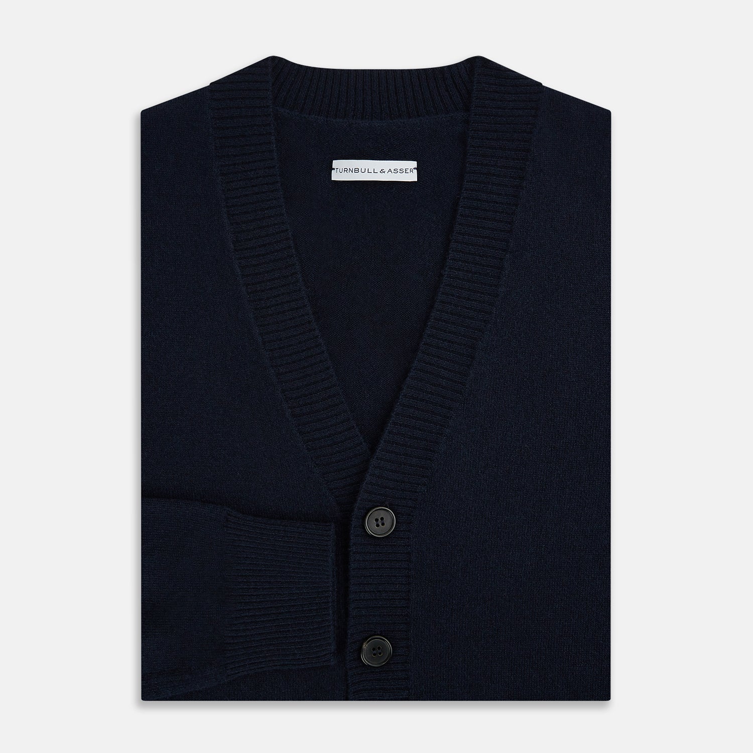 View 4 of product The Navy V-Neck Cashmere Cardigan by Turnbull & Asser features a button-up front, ribbed cuffs and hem, and two front pockets—a classic from our knitwear collection.