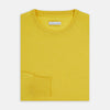 View 4 of product The Turnbull & Asser Canary Yellow Merino Round Neck Jumper features long sleeves and a crew neckline, shown here against a white background.