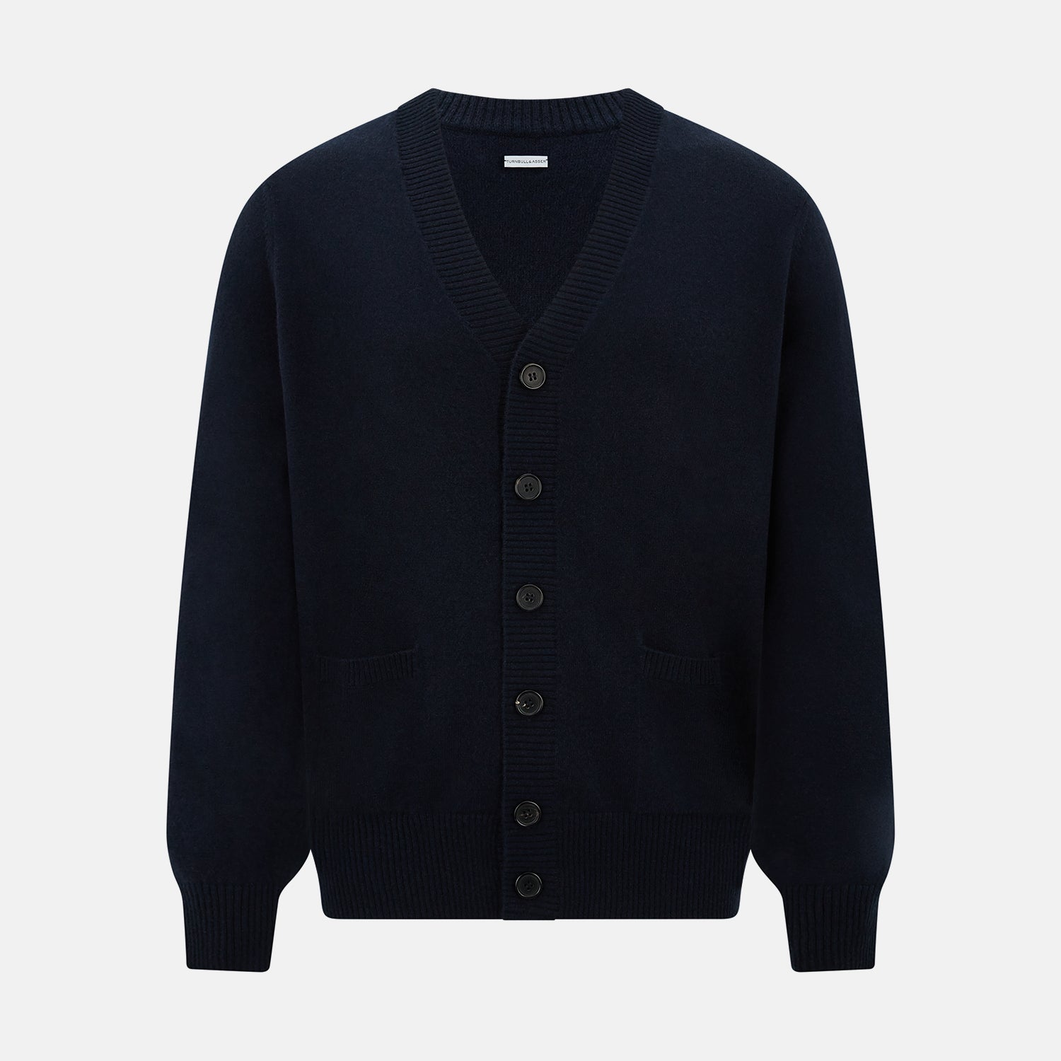 View 1 of product The Navy V-Neck Cashmere Cardigan by Turnbull & Asser features a button-up front, ribbed cuffs and hem, and two front pockets—a classic from our knitwear collection.