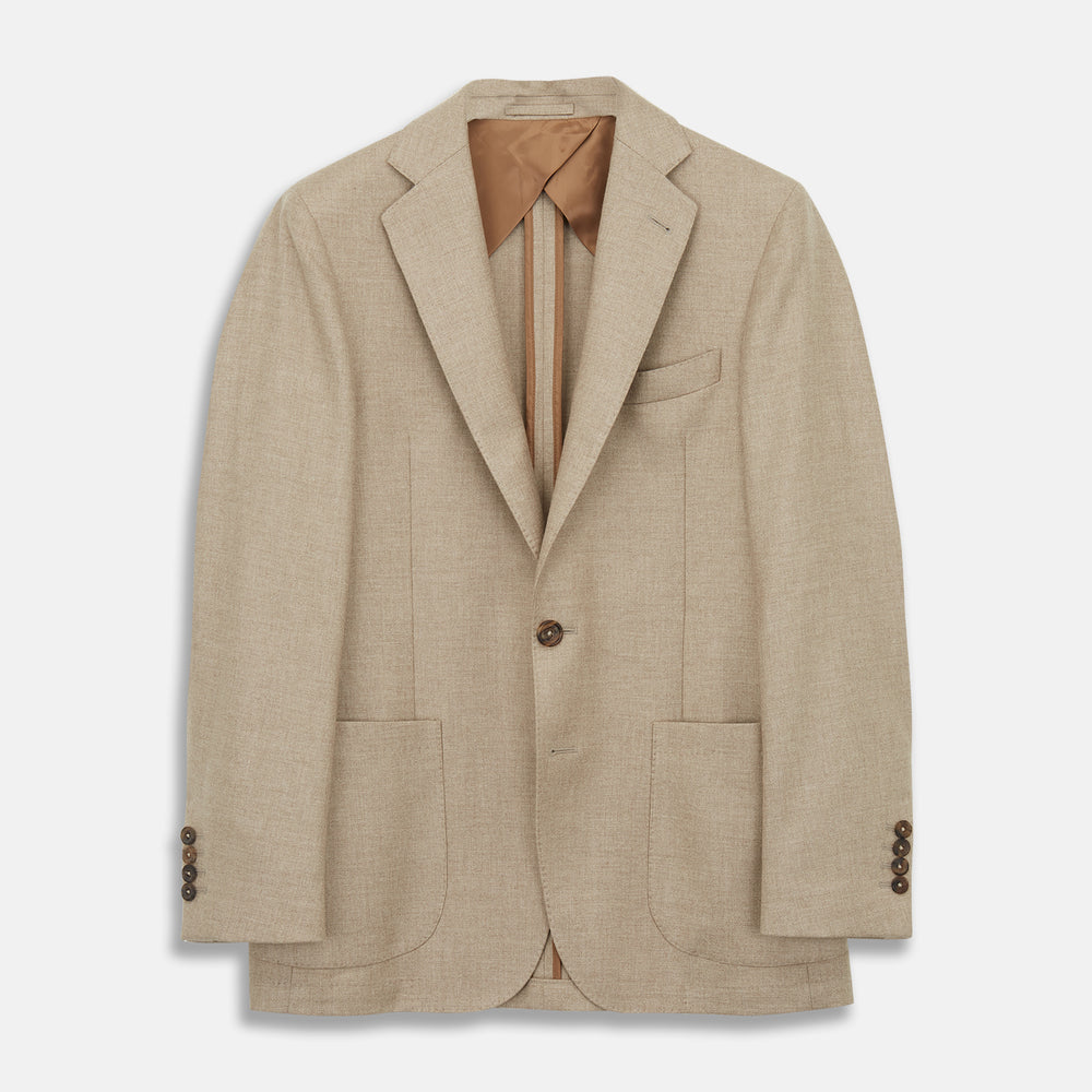 A man wearing the Beige Wool, Silk and Cashmere Bern Jacket by Turnbull & Asser over a matching shirt and olive green pants stands against a plain light gray background, looking to his left with a neutral expression.