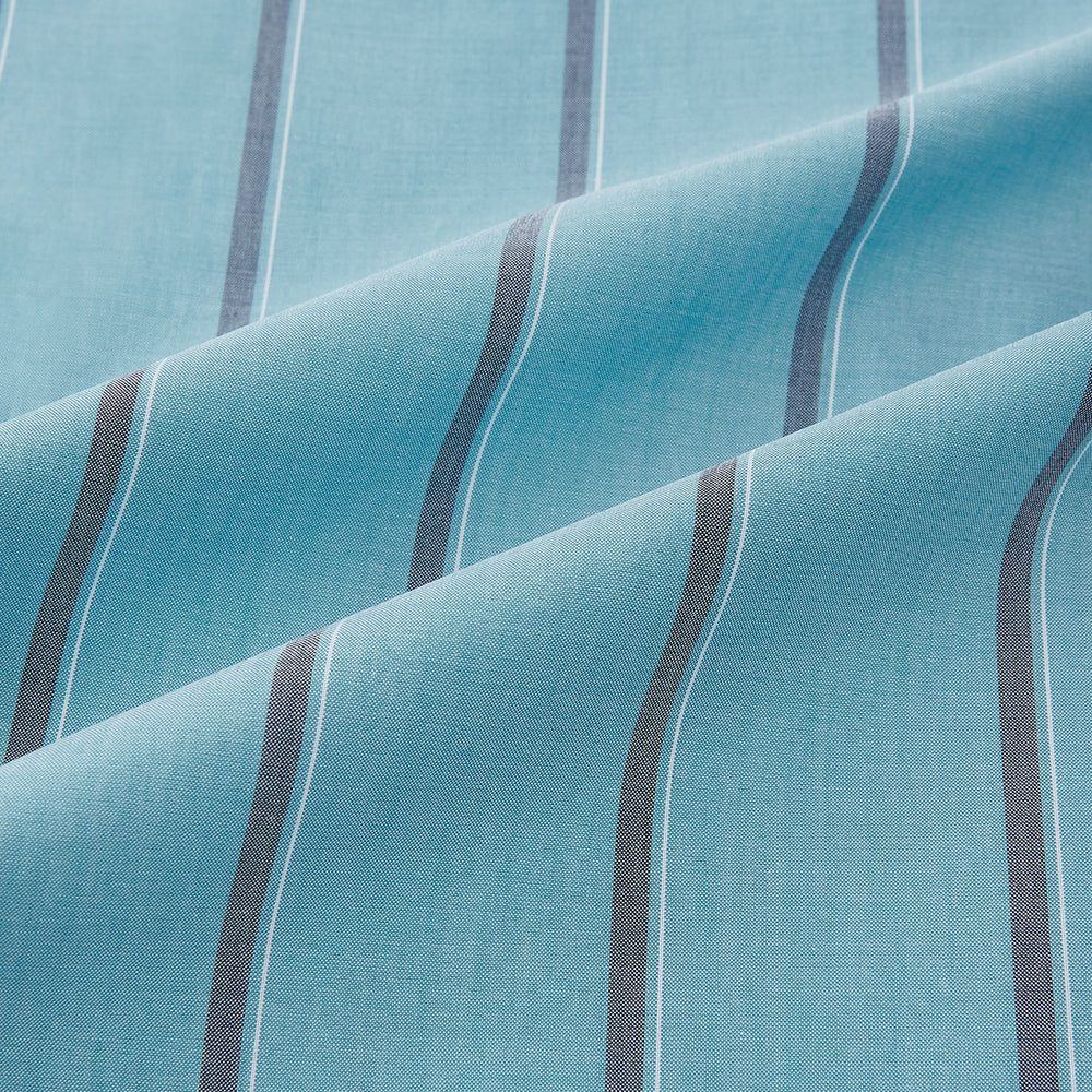 The Cendre Blue Track Stripe Westminster Shirt by Turnbull & Asser features a light blue hue, dark vertical stripes, button-down front, classic collar, and buttoned cuffs—showcasing British craftsmanship.