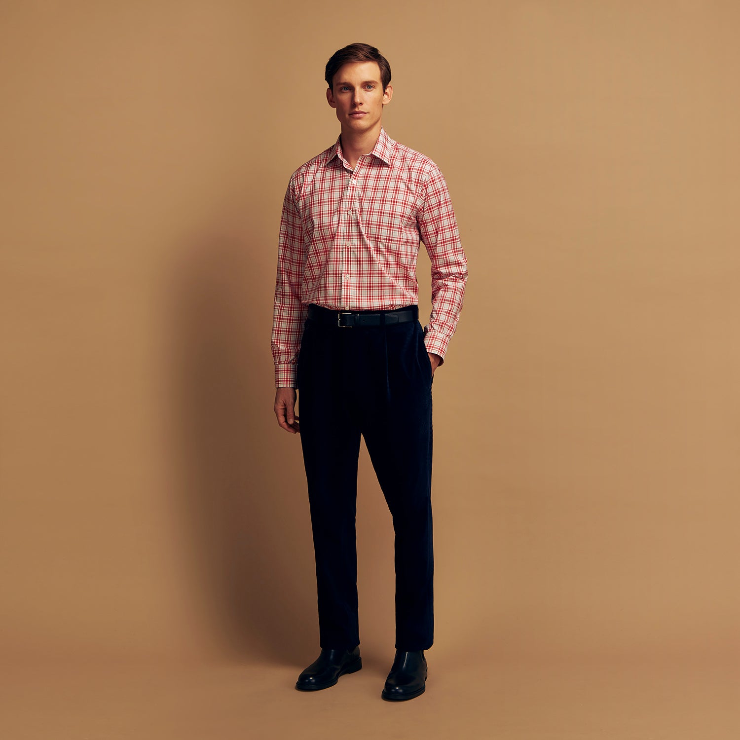View 2 of product The Turnbull & Asser Red Check Cotton Weekend Fit Finch Shirt is a men's long-sleeved, button-up shirt with a Derby collar and red-and-white plaid pattern, displayed flat on a white background.
