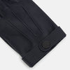 View 2 of product A pair of Navy Hairsheep Leather Touchscreen Driving Gloves by Turnbull & Asser is displayed, one palm up and one palm down. Crafted in Britain, the gloves feature vent holes, decorative stitching, and a snap button closure.