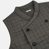 View 2 of product The Turnbull & Asser Shadow Grey Double-Breasted Quilted Gilet features a sleeveless design, asymmetrical collar, side zip pockets, slanted chest pocket, grid pattern, and modern black buttons—perfect for layered dressing.
