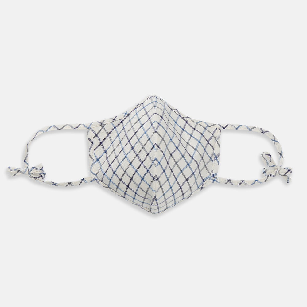 The Turnbull & Asser Check Blue Multi Commuter Mask features a blue plaid design, adjustable fabric ear loops tied in bows, and comes with 3 Viroformula™ filters. Laid flat on a white background.