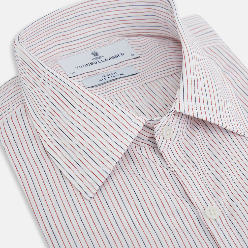 The Turnbull & Asser Red and Blue Ticking Stripe Westminster Shirt features long sleeves, a button-up front, pointed collar, and buttoned cuffs, highlighting British craftsmanship while laid flat on a white background.
